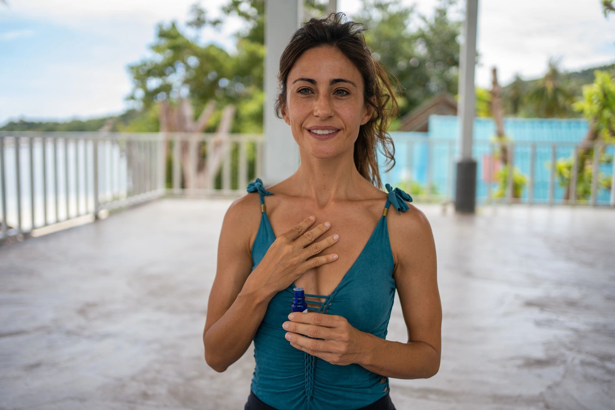 Wellness practitioner applying essential oil in a calm setting