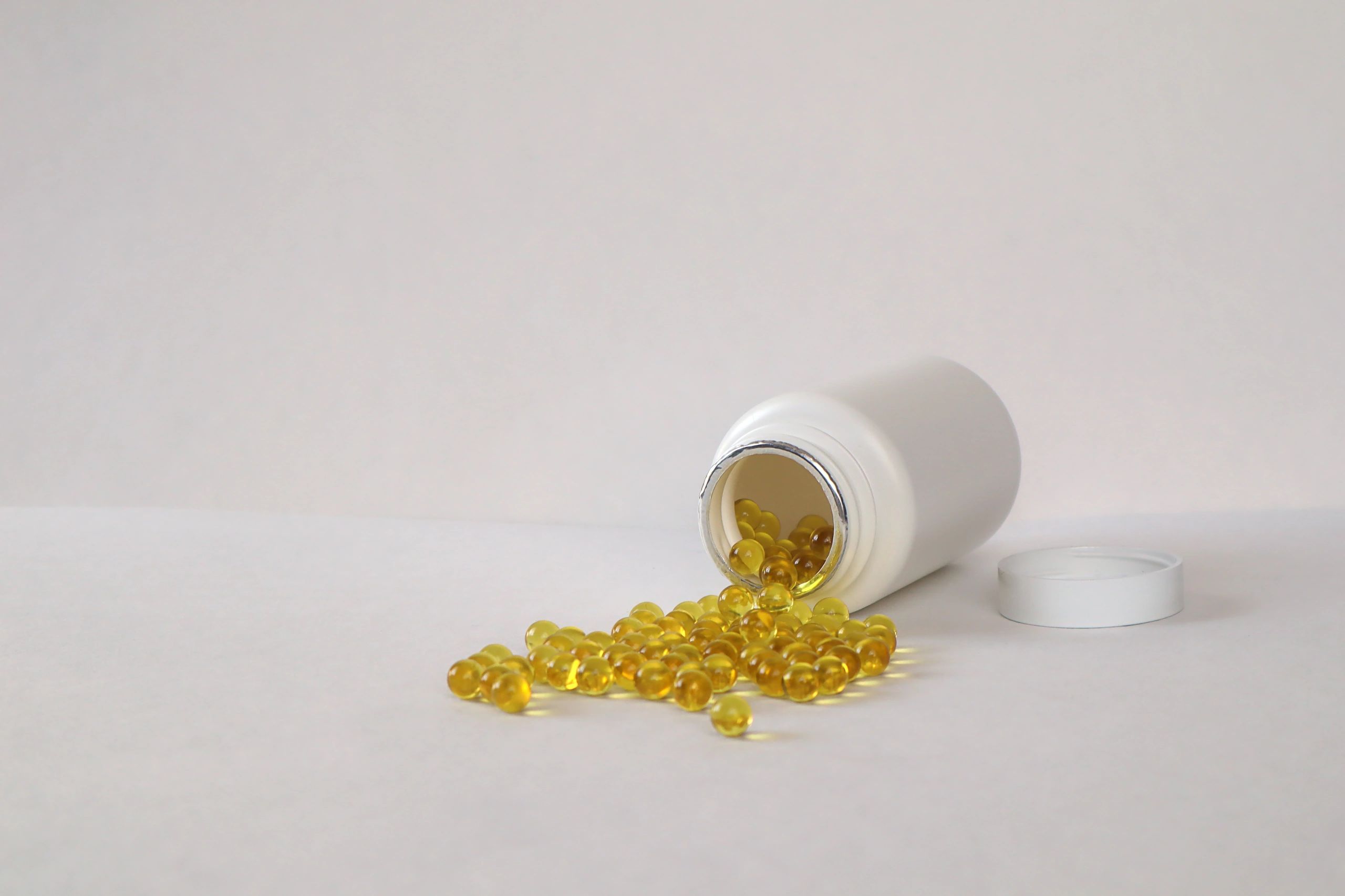 Wellness supplements and jar on a clean background
